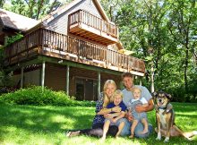 Dog with family in front of new home